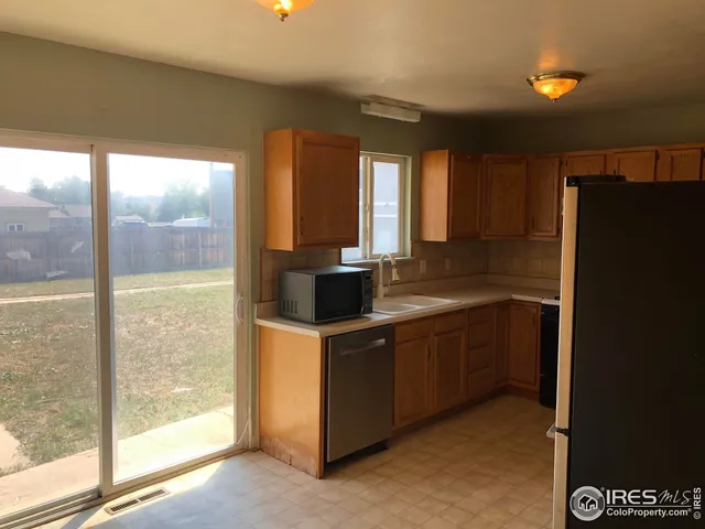 a kitchen with a sink and large window