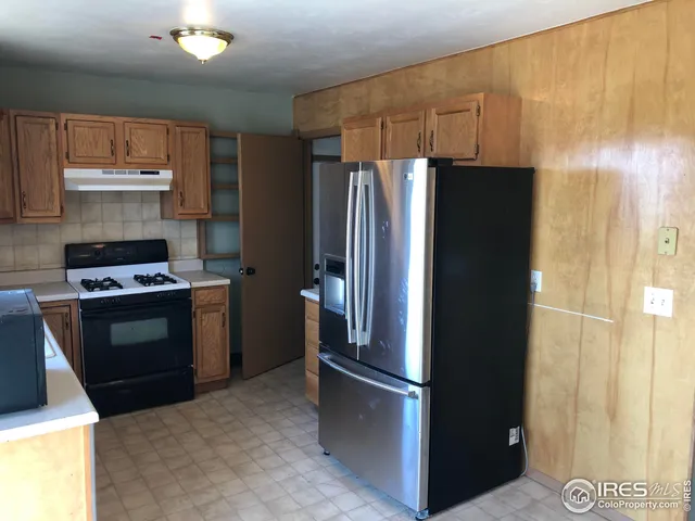 a kitchen with a refrigerator and a stove