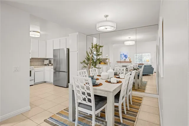 a view of a kitchen with furniture and stainless steel appliances