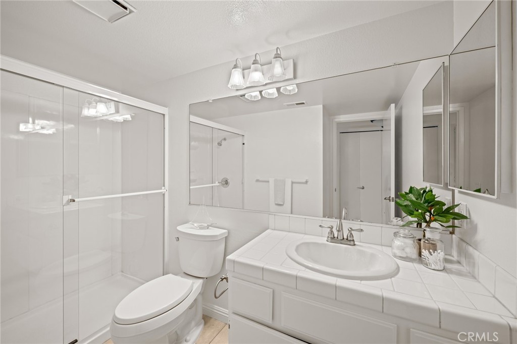 34004 Selva Road, Unit 377 Dana Point, CA 92629 - Photo 17 of 38 a bathroom with a sink a toilet and shower