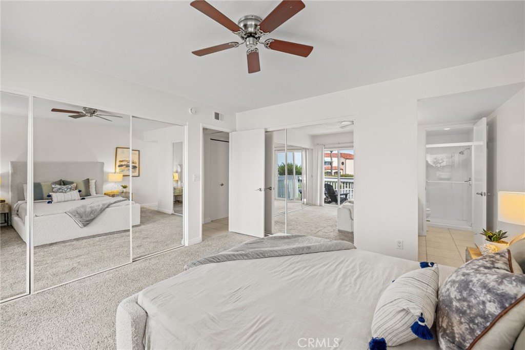 34004 Selva Road, Unit 377 Dana Point, CA 92629 - Photo 25 of 38 a bedroom with a large bed and ceiling fan