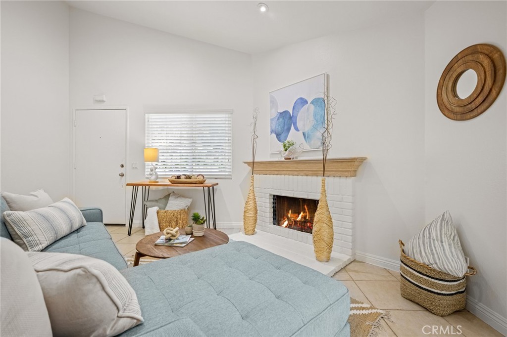 34004 Selva Road, Unit 377 Dana Point, CA 92629 - Photo 7 of 38 a living room with furniture and a fireplace