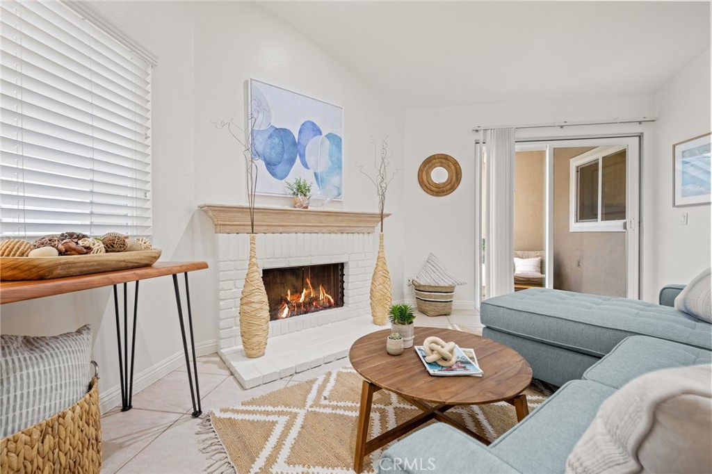 34004 Selva Road, Unit 377 Dana Point, CA 92629 - Photo 9 of 38 a living room with furniture and a fireplace