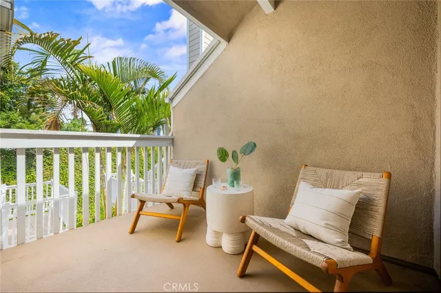 a kitchen with refrigerator and chairs