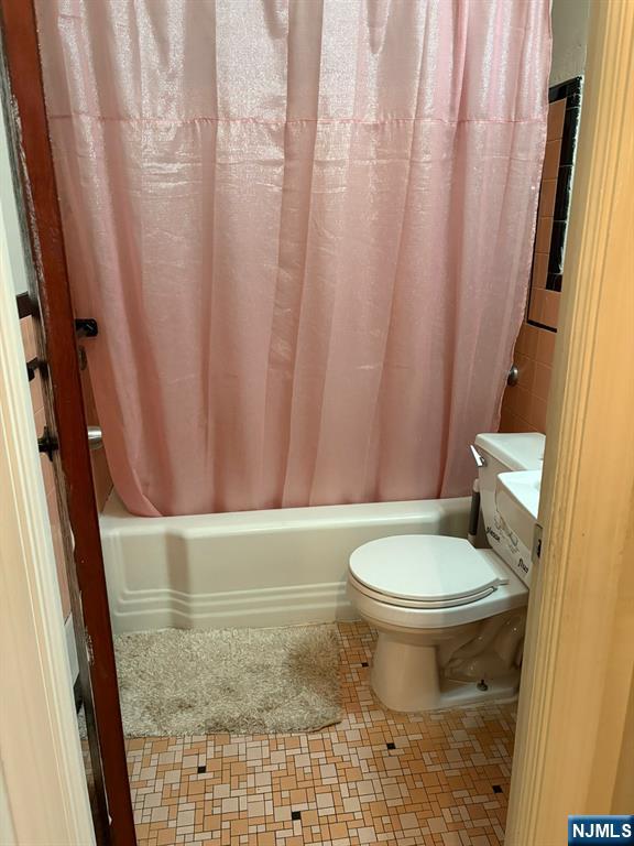 153 Madison Avenue Rochelle Park, NJ 07662 - Photo 13 of 26 a bathroom with a toilet and a shower curtain