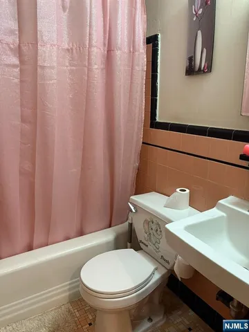 a bathroom with a toilet and a sink
