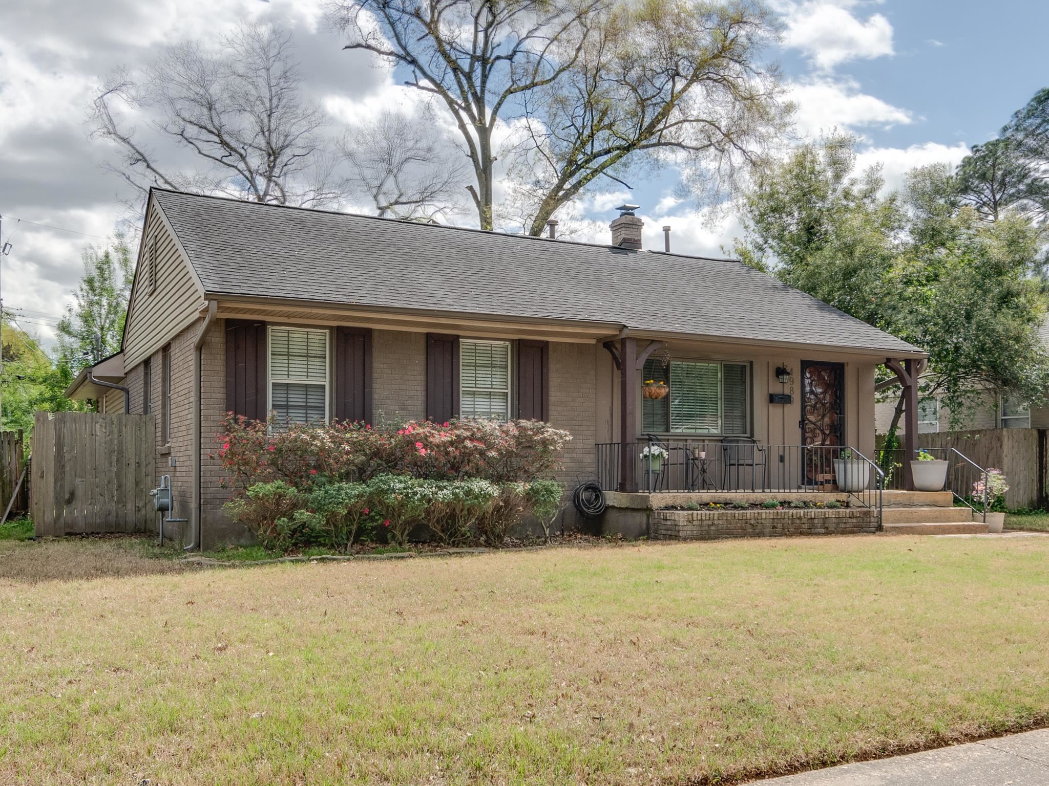 4989 Princeton Road Memphis, TN 38117 - Photo 3 of 39 a front view of house with yard and trees in the background