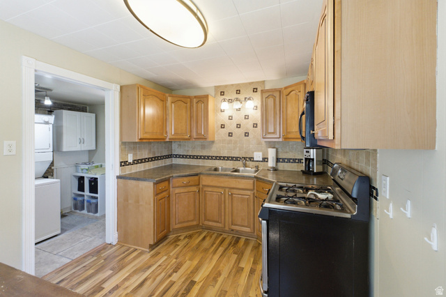 94 West 2000th Street North Clearfield, UT 84015 - Photo 12 of 26 Functional kitchen with tile backsplash, generous cabinet storage, and adjoining laundry/utility room.