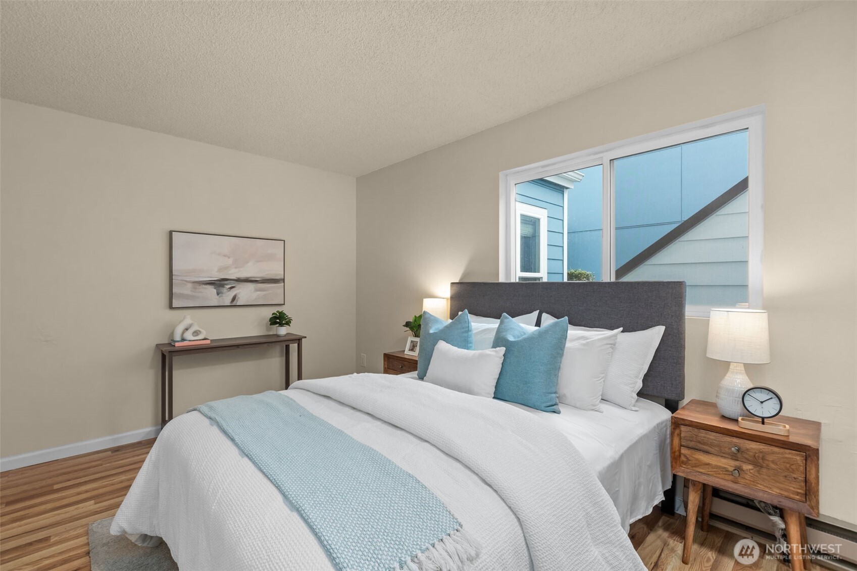 2001 East Yesler Way, Unit 46 Seattle, WA 98122 - Photo 11 of 20 a bedroom with a bed and a lamp on table