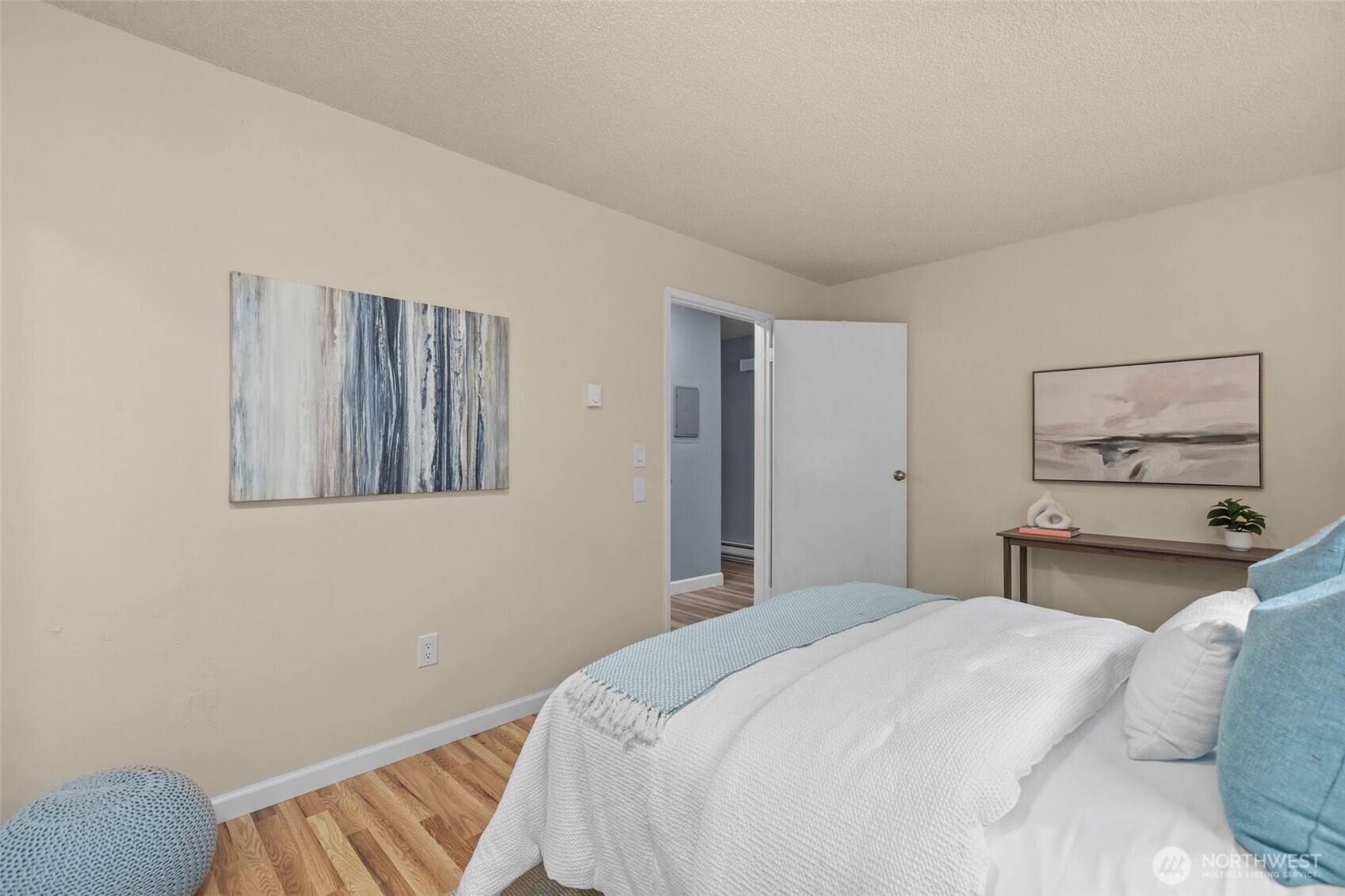 2001 East Yesler Way, Unit 46 Seattle, WA 98122 - Photo 12 of 20 a bedroom with a bed and a painting on the wall