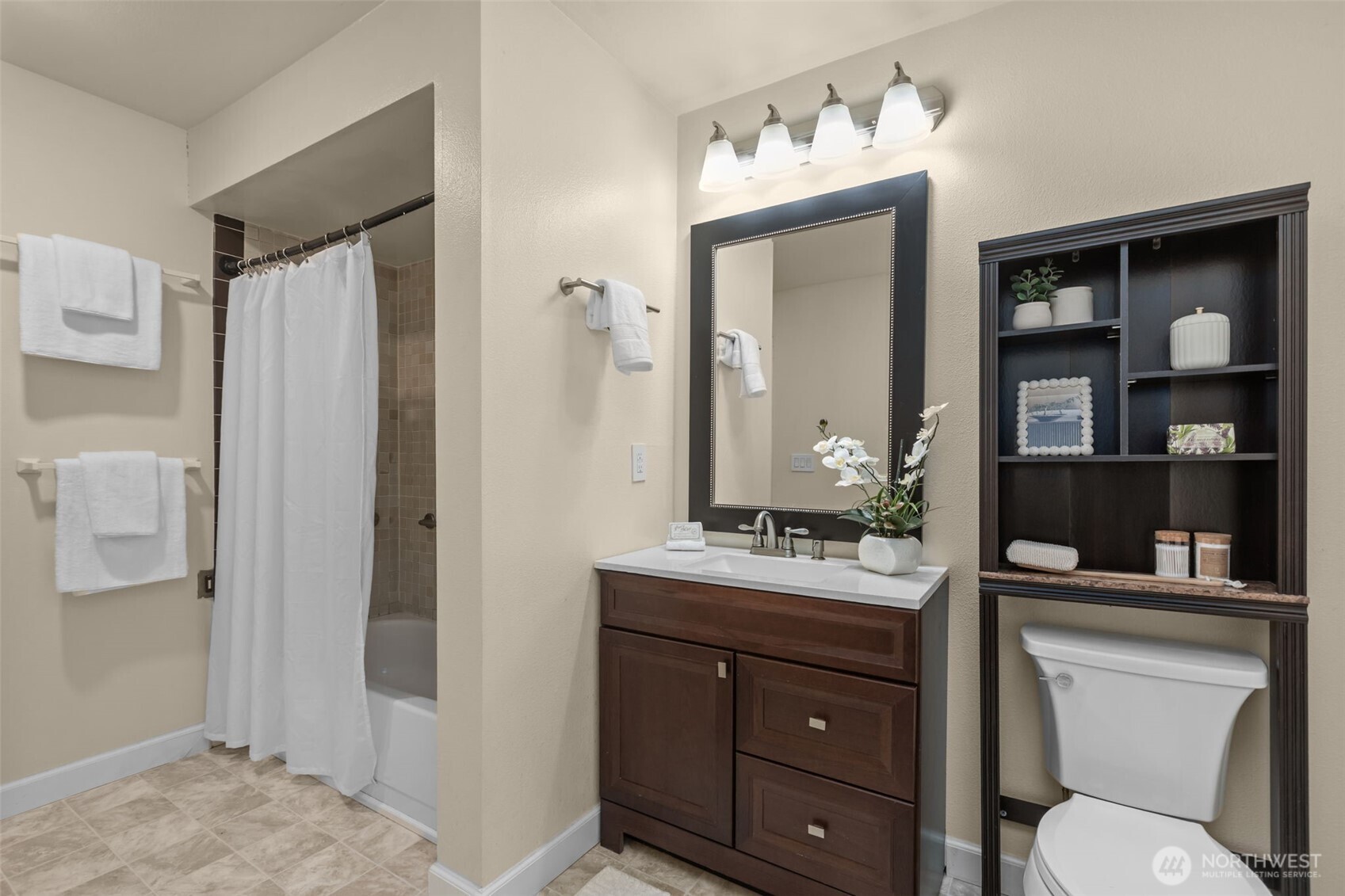 2001 East Yesler Way, Unit 46 Seattle, WA 98122 - Photo 15 of 20 a bathroom with a toilet a sink and a mirror