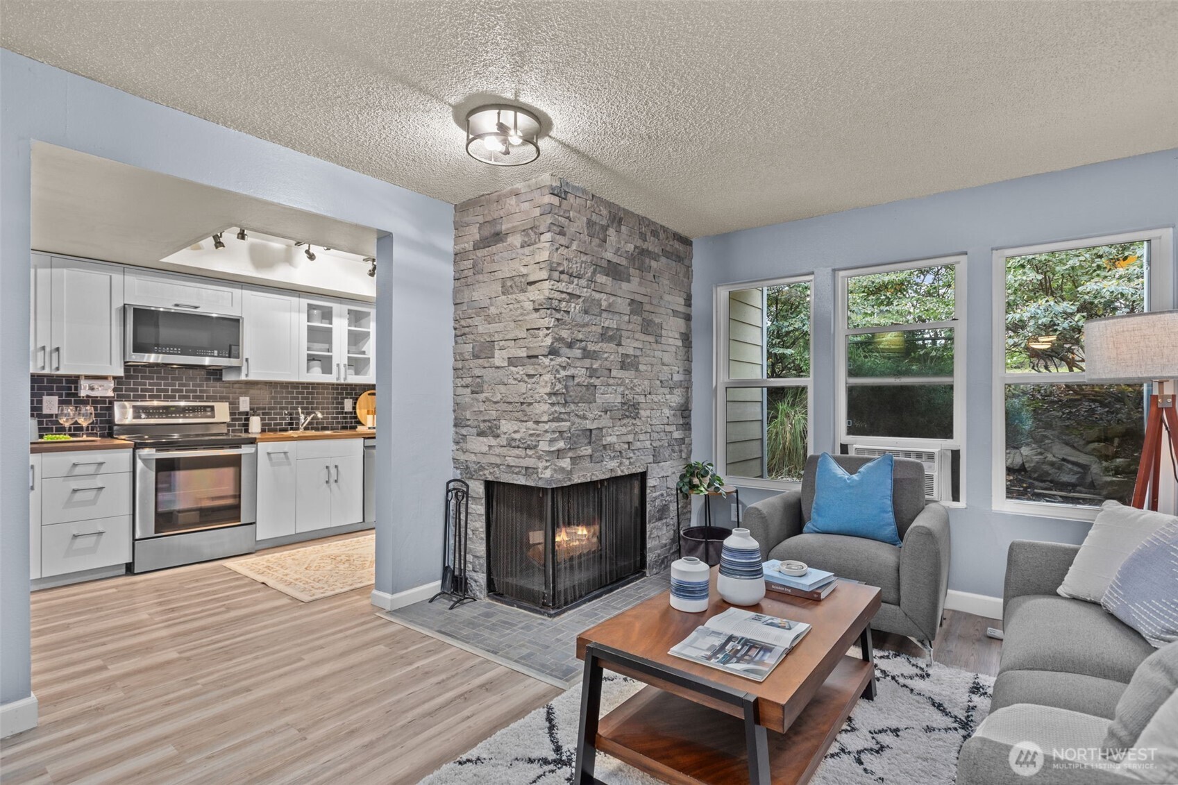 2001 East Yesler Way, Unit 46 Seattle, WA 98122 - Photo 2 of 20 a living room with furniture fireplace and a large window
