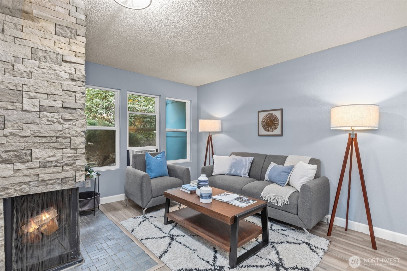 2001 East Yesler Way, Unit 46 Seattle, WA 98122 - Photo 3 of 20 a living room with furniture and a fireplace