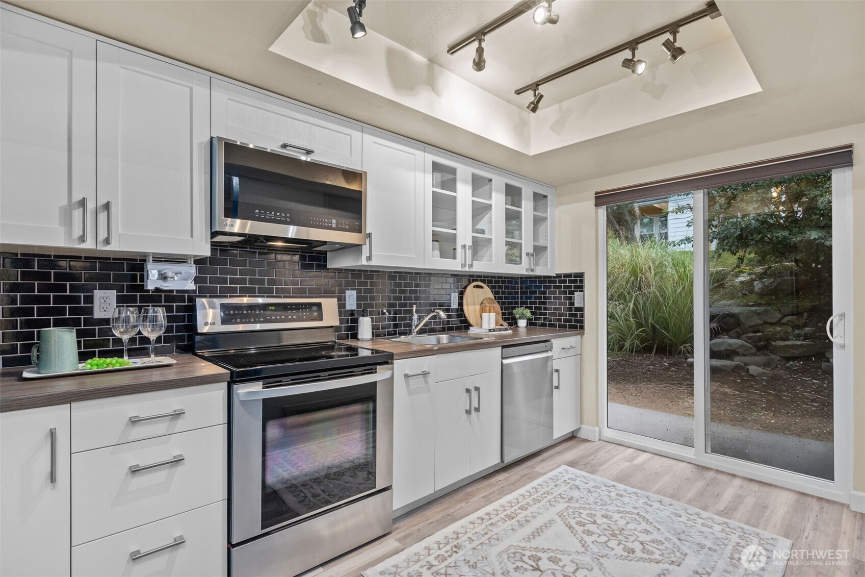 2001 East Yesler Way, Unit 46 Seattle, WA 98122 - Photo 7 of 20 a kitchen with stainless steel appliances granite countertop a stove and cabinets