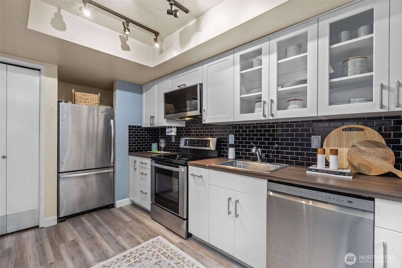 2001 East Yesler Way, Unit 46 Seattle, WA 98122 - Photo 9 of 20 a kitchen with stainless steel appliances granite countertop a refrigerator and a stove top oven