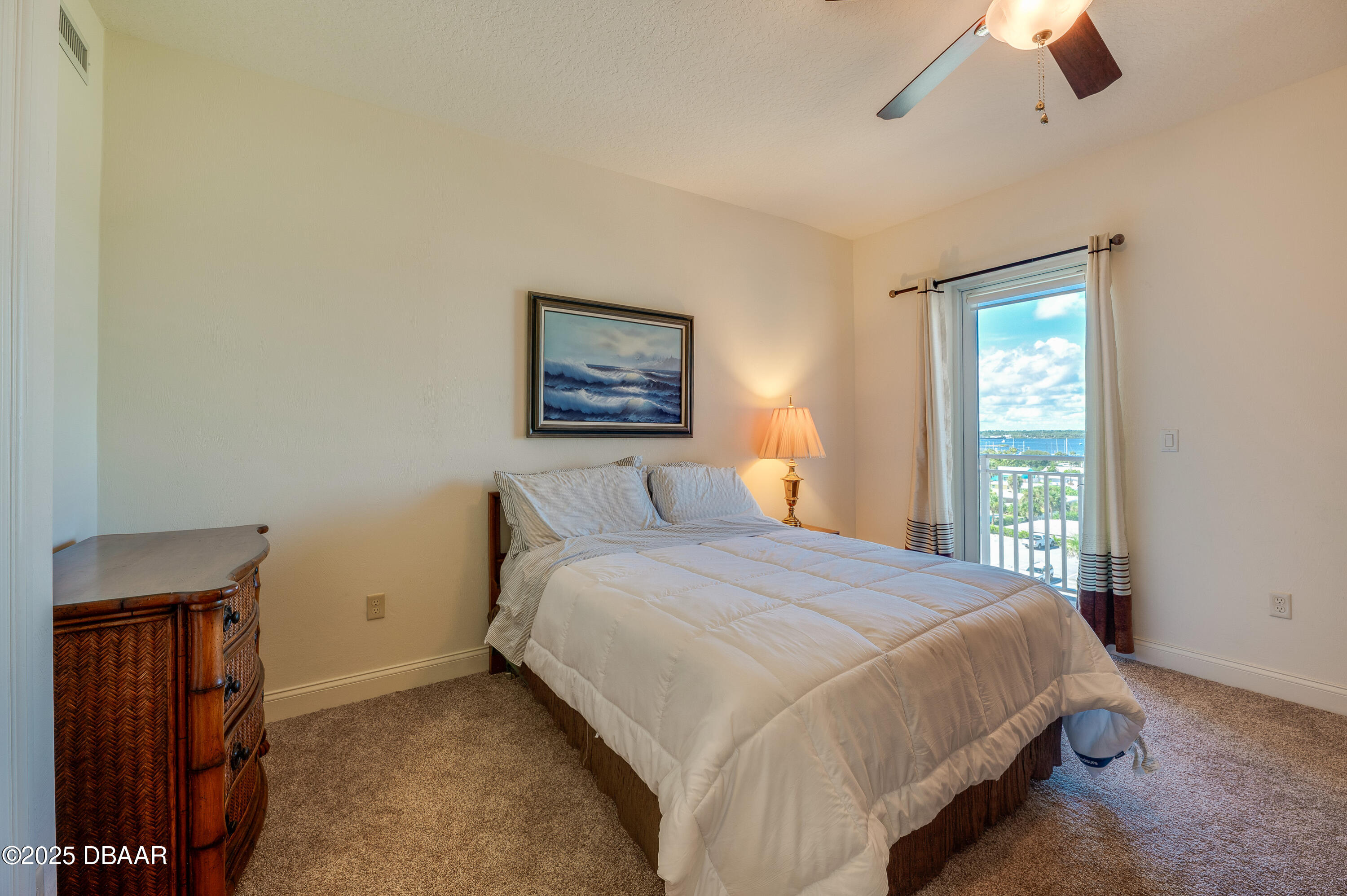 3245 South Atlantic Avenue, Unit 601 Daytona Beach, FL 32118 - Photo 23 of 48 a bedroom with a bed and a window