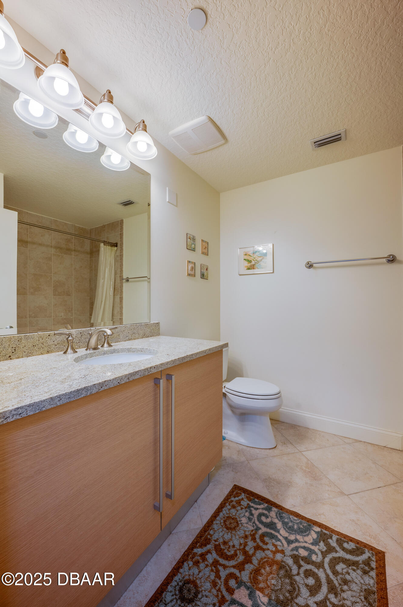 3245 South Atlantic Avenue, Unit 601 Daytona Beach, FL 32118 - Photo 27 of 48 a bathroom with a sink a toilet and a mirror