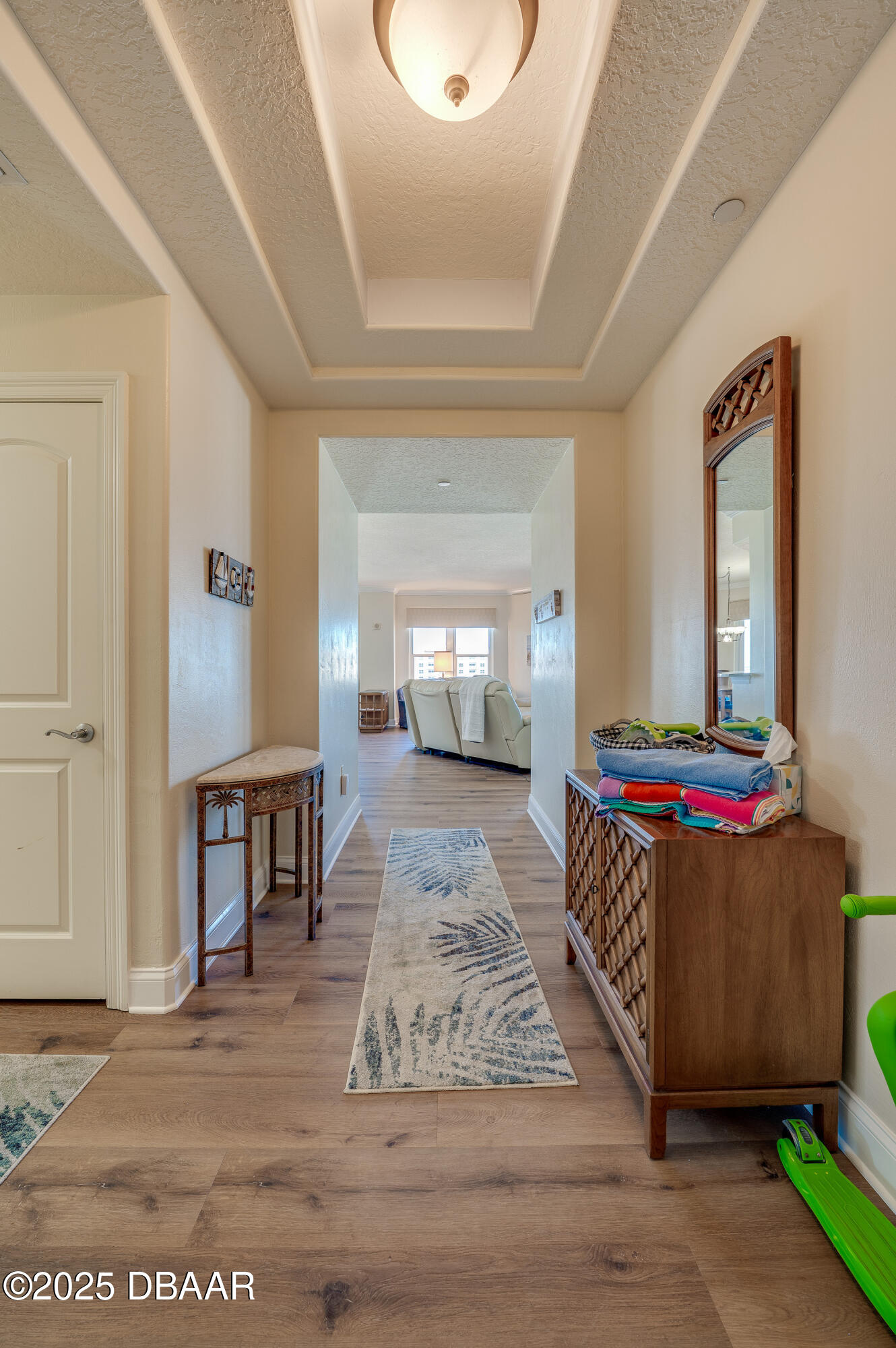 3245 South Atlantic Avenue, Unit 601 Daytona Beach, FL 32118 - Photo 7 of 48 a living room with a couch and a dining table with wooden floor