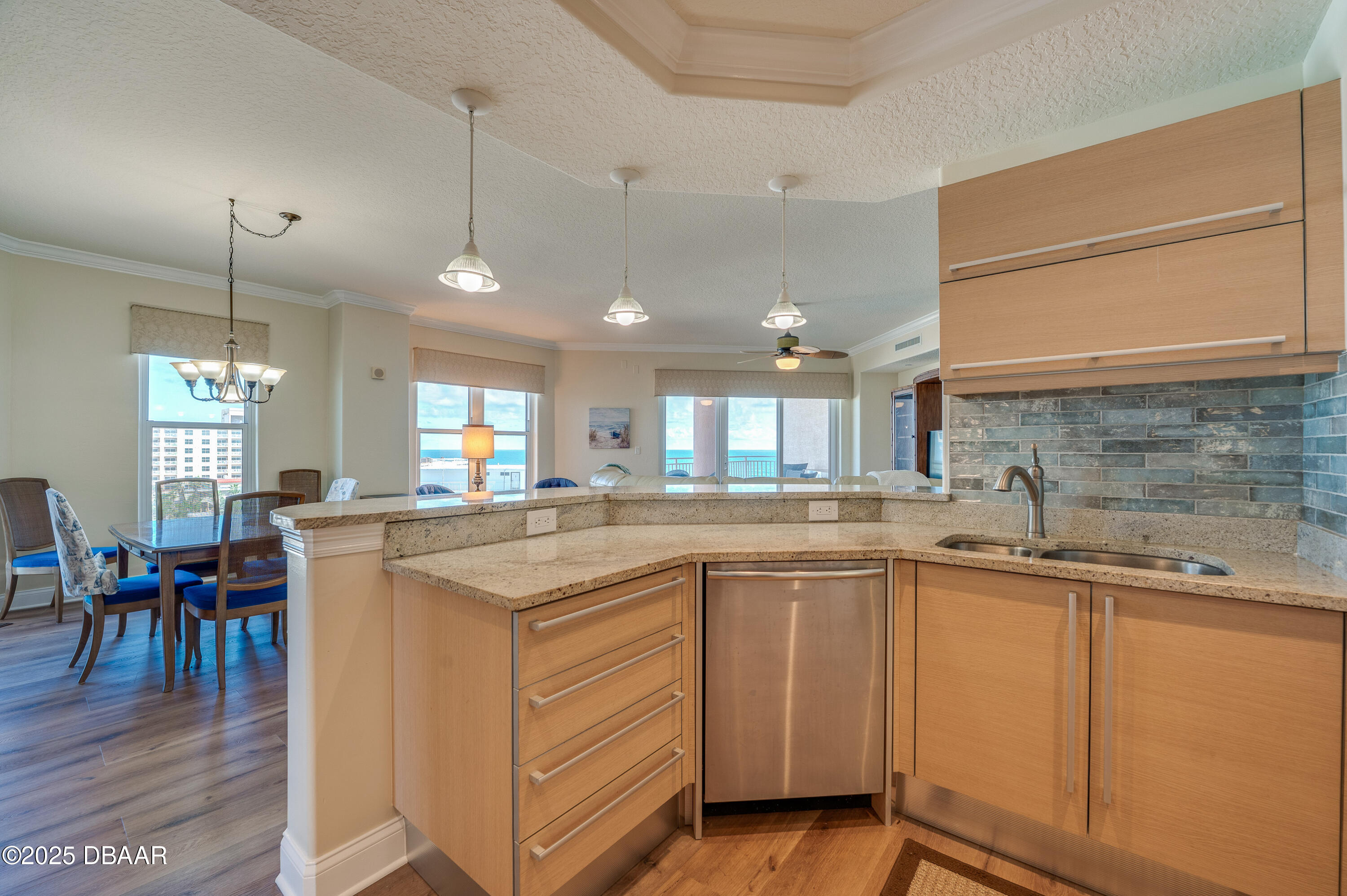 3245 South Atlantic Avenue, Unit 601 Daytona Beach, FL 32118 - Photo 10 of 48 a kitchen with cabinets a sink and appliances