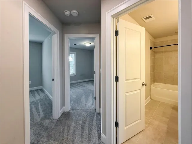 a view of a bathroom with a glass door shower