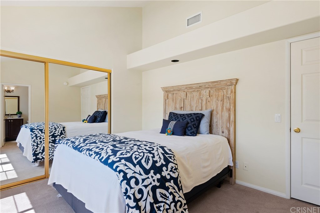 4341 Freedom Drive, Unit B Calabasas, CA 91302 - Photo 17 of 20 a bedroom with a large bed and a chandelier