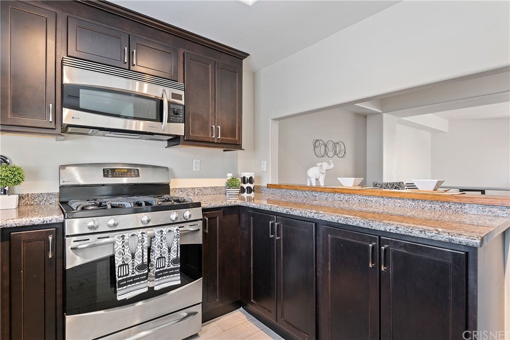 4341 Freedom Drive, Unit B Calabasas, CA 91302 - Photo 10 of 20 a kitchen with stainless steel appliances granite countertop a stove microwave and sink