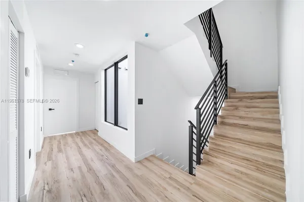 a view of entryway with wooden floor