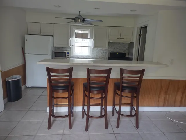 a kitchen with stainless steel appliances a sink counter space and a refrigerator