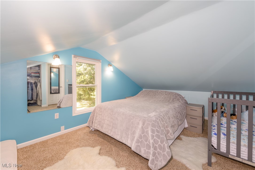 4051 Stow Road Stow, OH 44224 - Photo 27 of 38 Bedroom with a closet, vaulted ceiling, and light carpet