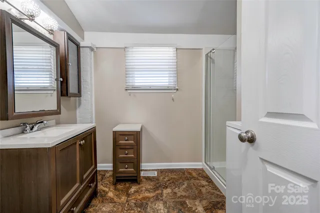 a bathroom with a sink a toilet and mirror