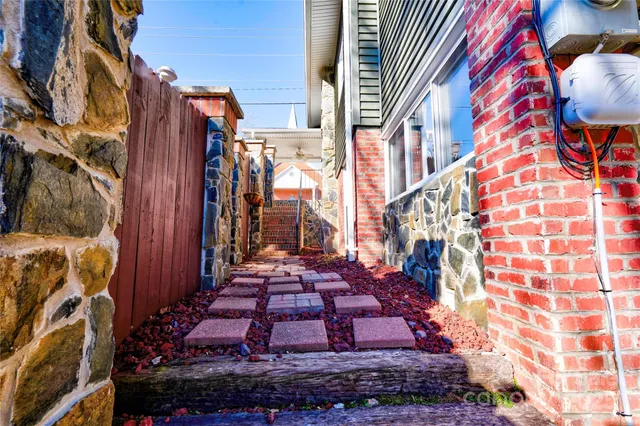 a bedroom with a bed and a curtain