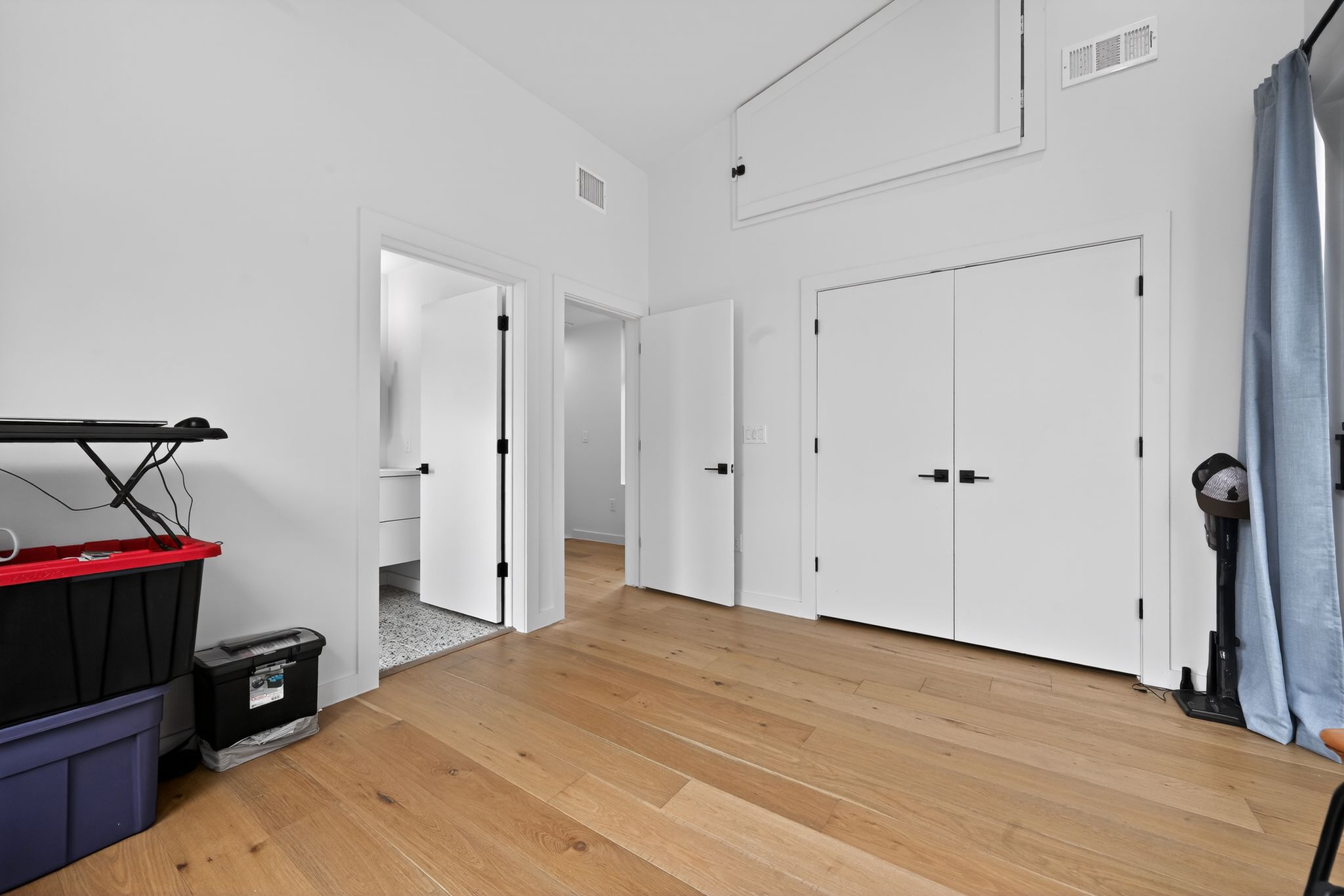 1206 Luna Street, Unit 2 Austin, TX 78721 - Photo 22 of 30 This space features light hardwood floors, white walls, and multiple white doors