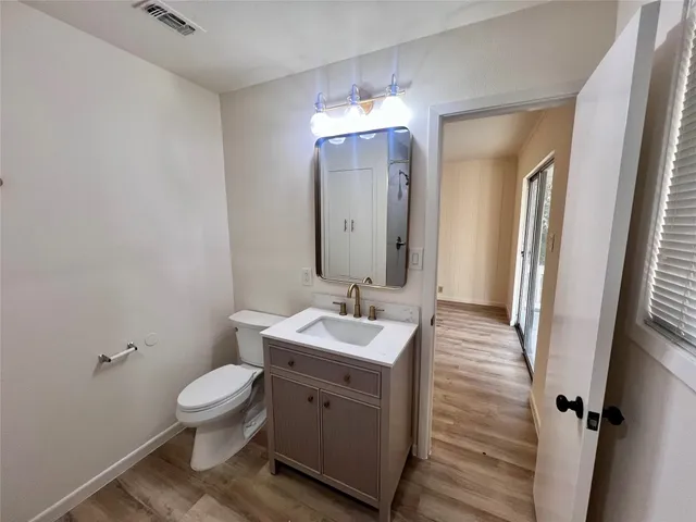 a bathroom with a sink toilet and mirror