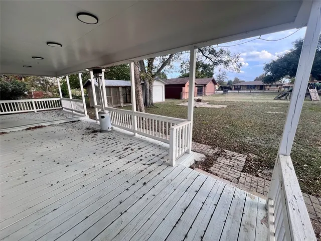 a view of a porch with wooden floor