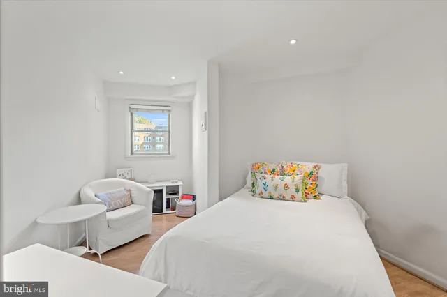 a bedroom with two beds and a couch