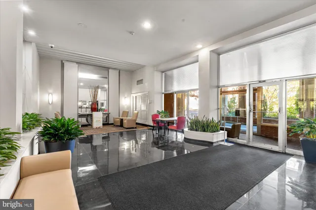 a living room with furniture and potted plants