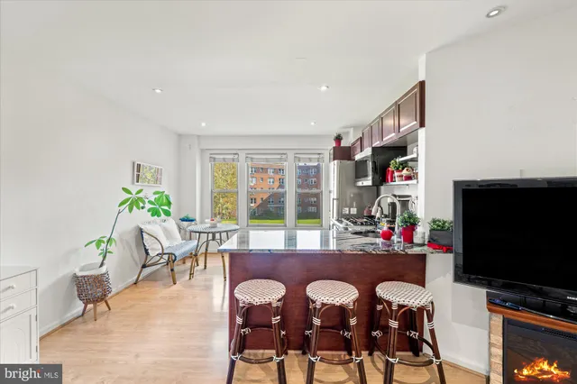 a view of a dining room with furniture and a flat screen tv