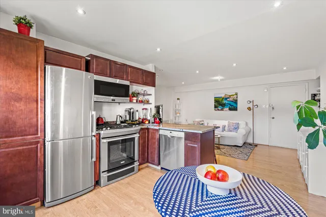 a kitchen with a sink cabinets and stainless steel appliances
