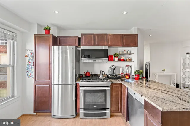 a kitchen with refrigerator and cabinets