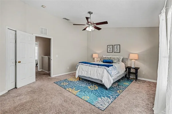 a bedroom with a bed and painting on the wall