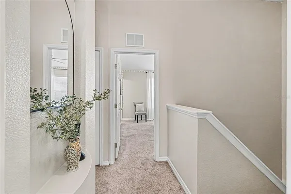 view of a hallway with wooden floor and a living room