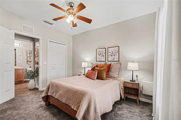 a bedroom with a bed and a lamp