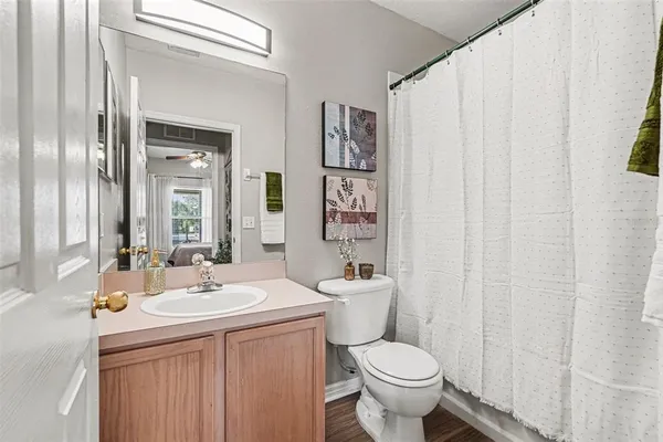 a bathroom with a sink toilet and shower
