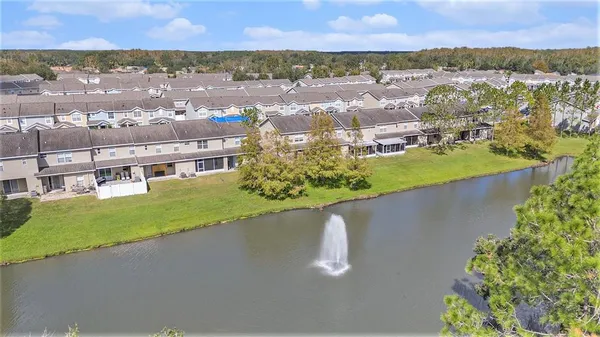 an aerial view of residential houses with outdoor space and river