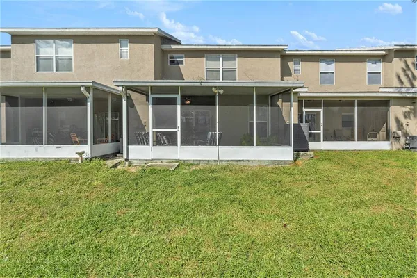 a view of a white house with large windows