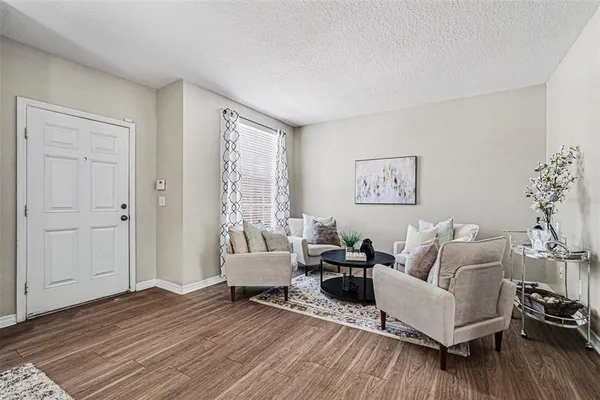 a living room with furniture and wooden floor