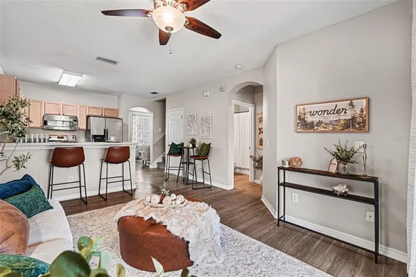 a living room with furniture and a wooden floor