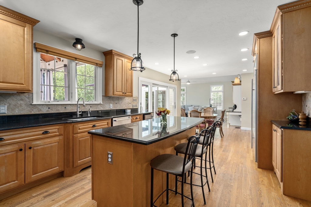 63 High Street Shrewsbury, MA 01545 - Photo 11 of 40 a kitchen with stainless steel appliances granite countertop a sink a stove and a refrigerator