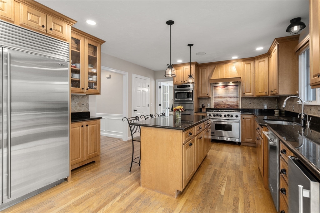 63 High Street Shrewsbury, MA 01545 - Photo 12 of 40 a kitchen with stainless steel appliances granite countertop a stove top oven a sink dishwasher a refrigerator and a cabinets