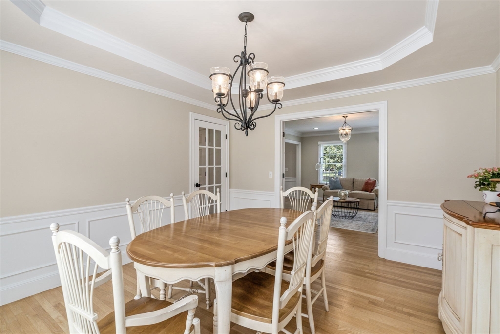 63 High Street Shrewsbury, MA 01545 - Photo 16 of 40 a view of a dining room with furniture a chandelier and wooden floor